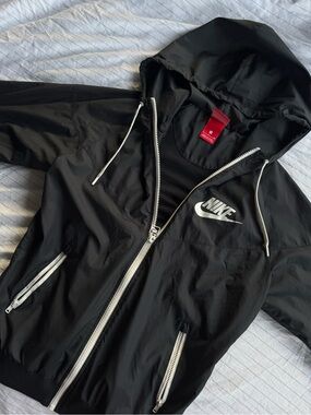 Nike Black Hooded Jacket with White Accents and Red Tag